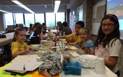 campers at table working on arts and crafts