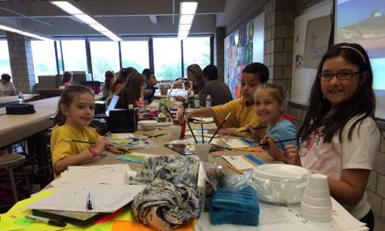 campers at table working on arts and crafts