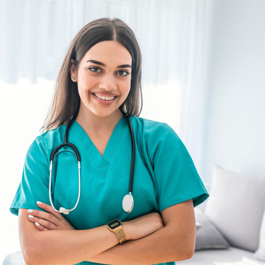 woman in hospital scrubs with stethoscope around her neck