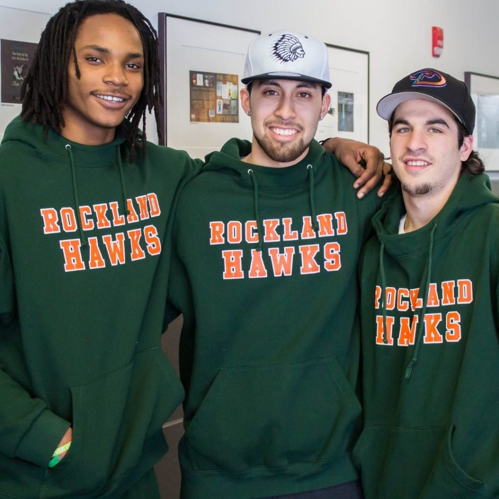 three students wearing Rockland Hawks sweatshirts