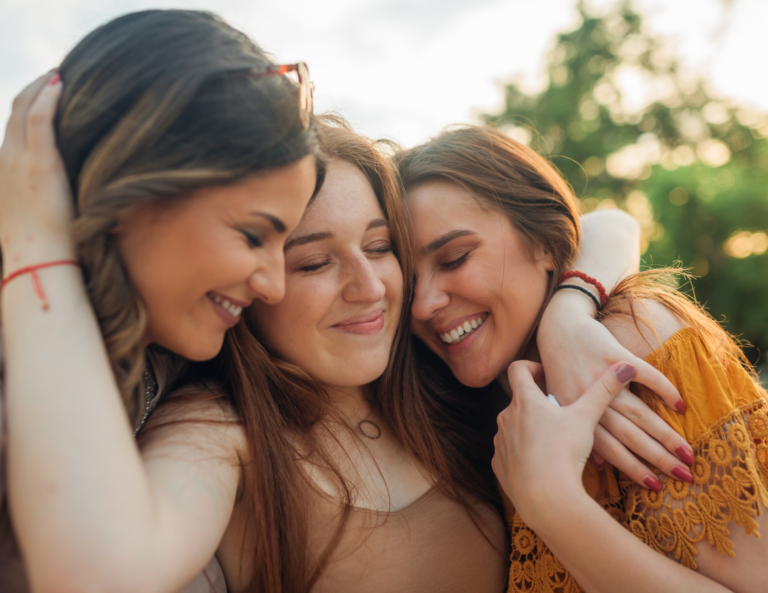 three women embracing each other