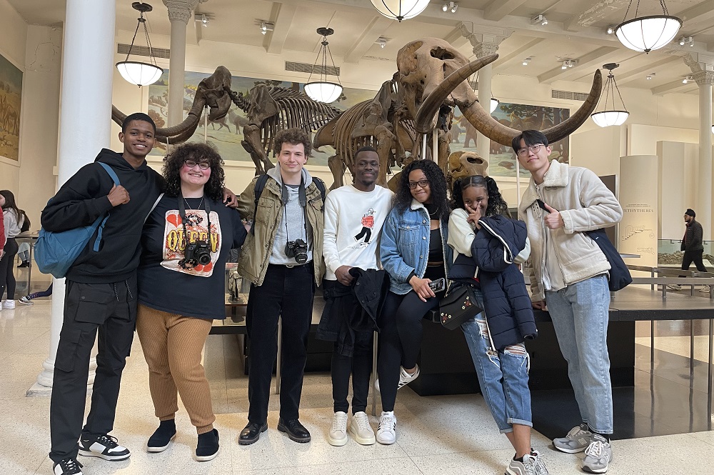 group of students in front of mammoth skeleton at museum