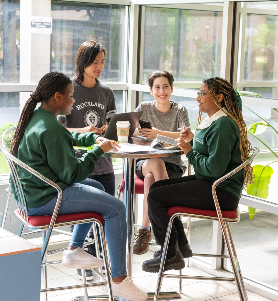 four students sitting at a table